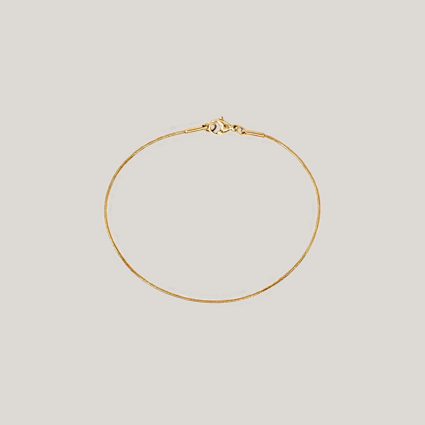 Thin round snake chain bracelet gold